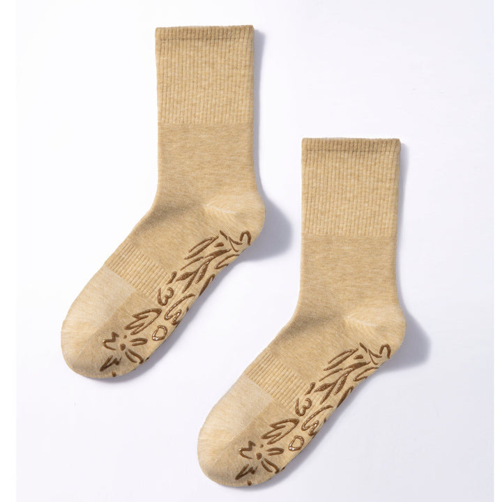 Pair of lemon-beige non-slip socks with brown grip pattern on toe