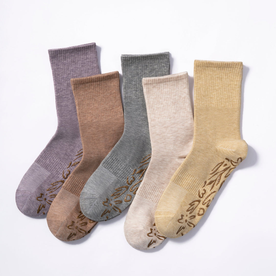 Assorted crew socks with floral non-slip grip prints; grey pair included