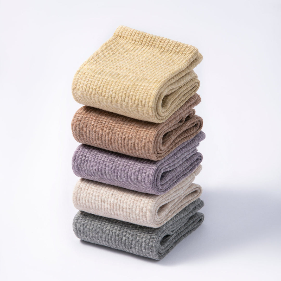 Stack of folded non-slip socks in cream, taupe, lavender and dark gray