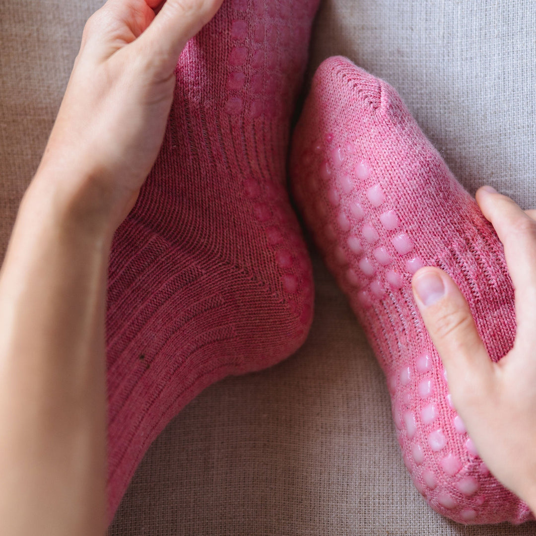 Coral sock pair with contrast cuffs, close-up of grippy sole pattern