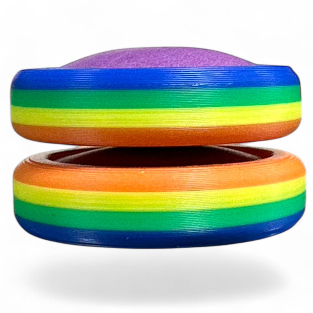 Rainbow pride ring stack with blue, green, yellow, orange, and rainbow top band.