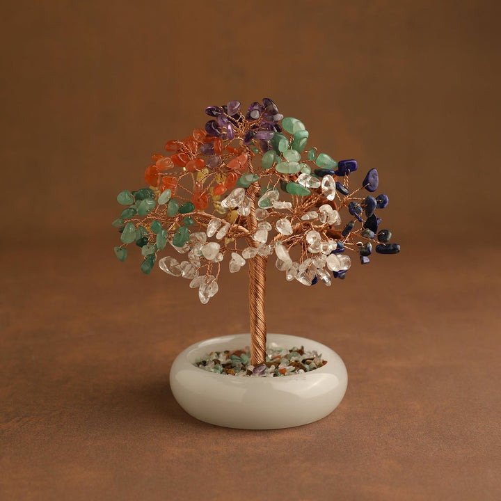 Multicolor crystal tree ornament on round white base with scattered stones top
