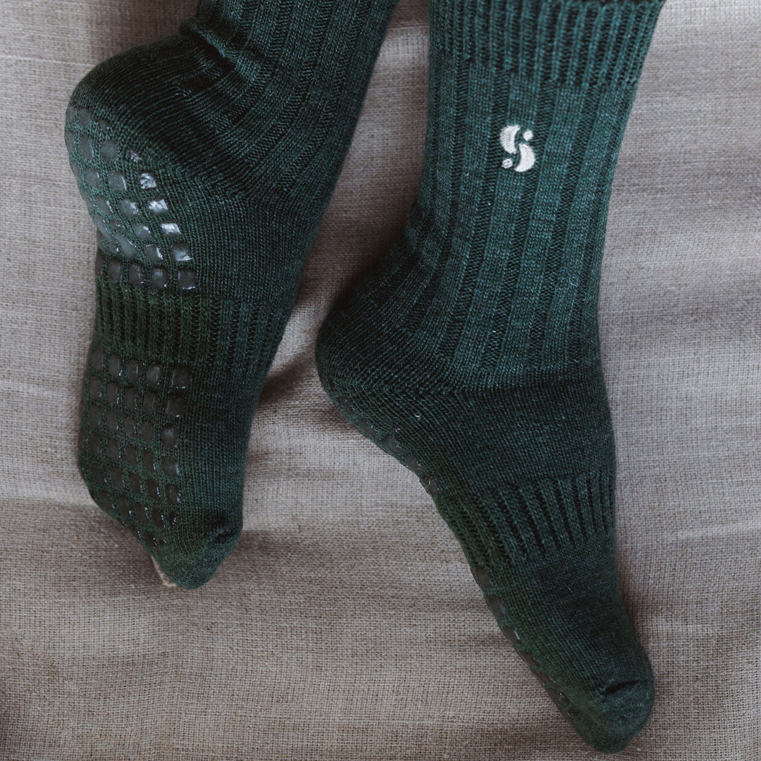 Serene Socks dark green merino wool non-slip socks, textured grip sole close-up