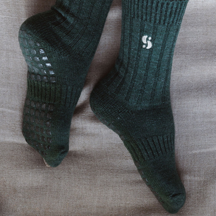 Serene Socks dark green merino wool non-slip socks, textured grip sole close-up