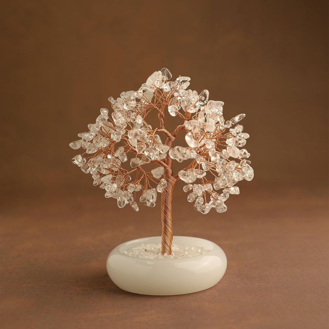 Clear quartz crystal tree with gold-toned wire trunk and round white base