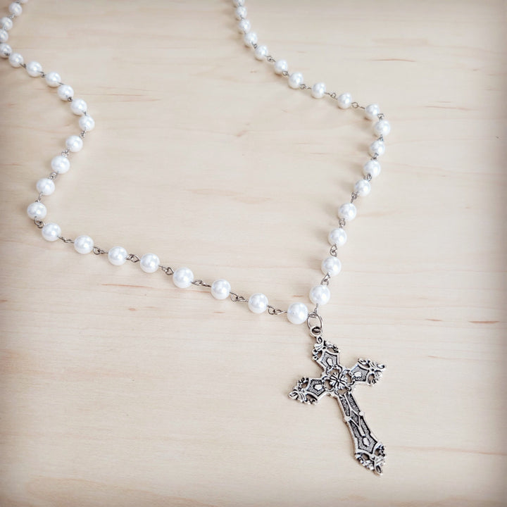 Long pearl beaded necklace with antique silver cross pendant