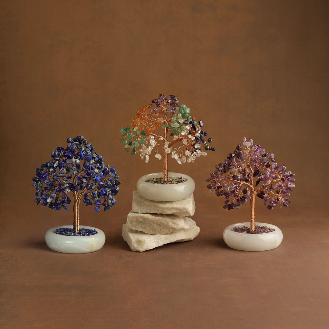 Three crystal gemstone trees with blue, multicolor, and purple branches