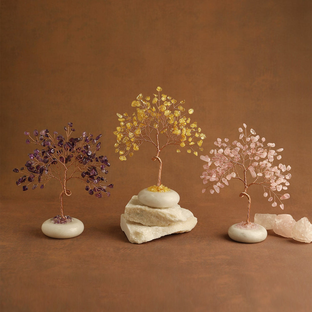 Crystal tree set with dark blue, golden yellow, and pink gemstone leaves on white bases