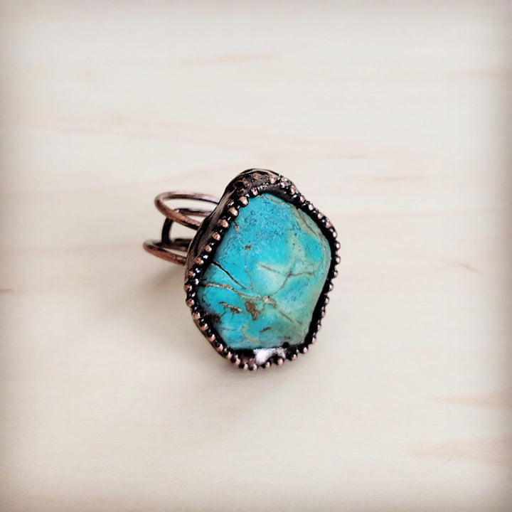 Oval turquoise statement ring with dark beaded frame and antique copper setting