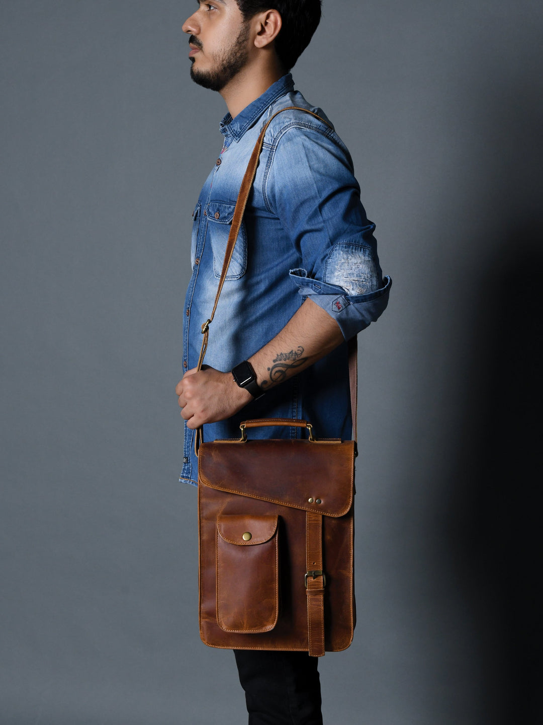 Brown leather crossbody bag worn on body, front flap and vertical pockets
