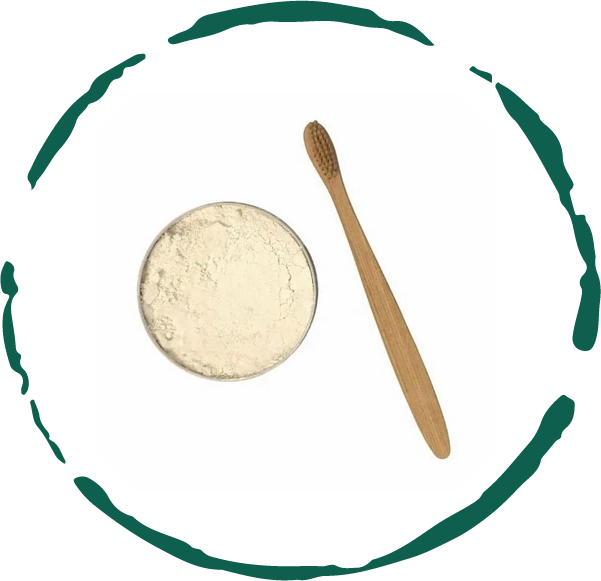 Tooth powder dish with pale beige powder and wooden scoop