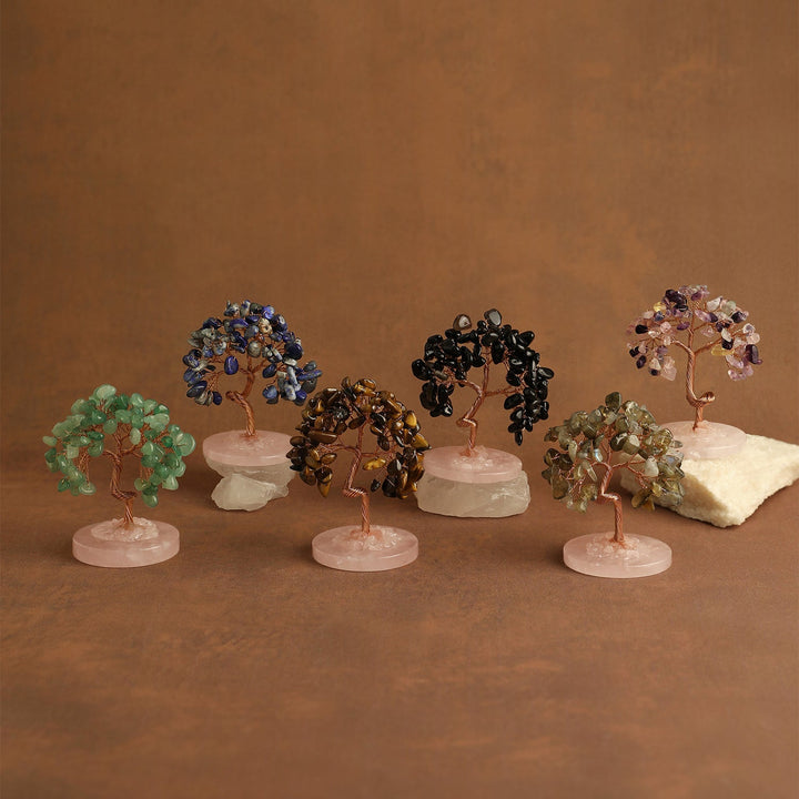 Set of mini gemstone crystal trees on pale pink round bases, multicolor stone branches