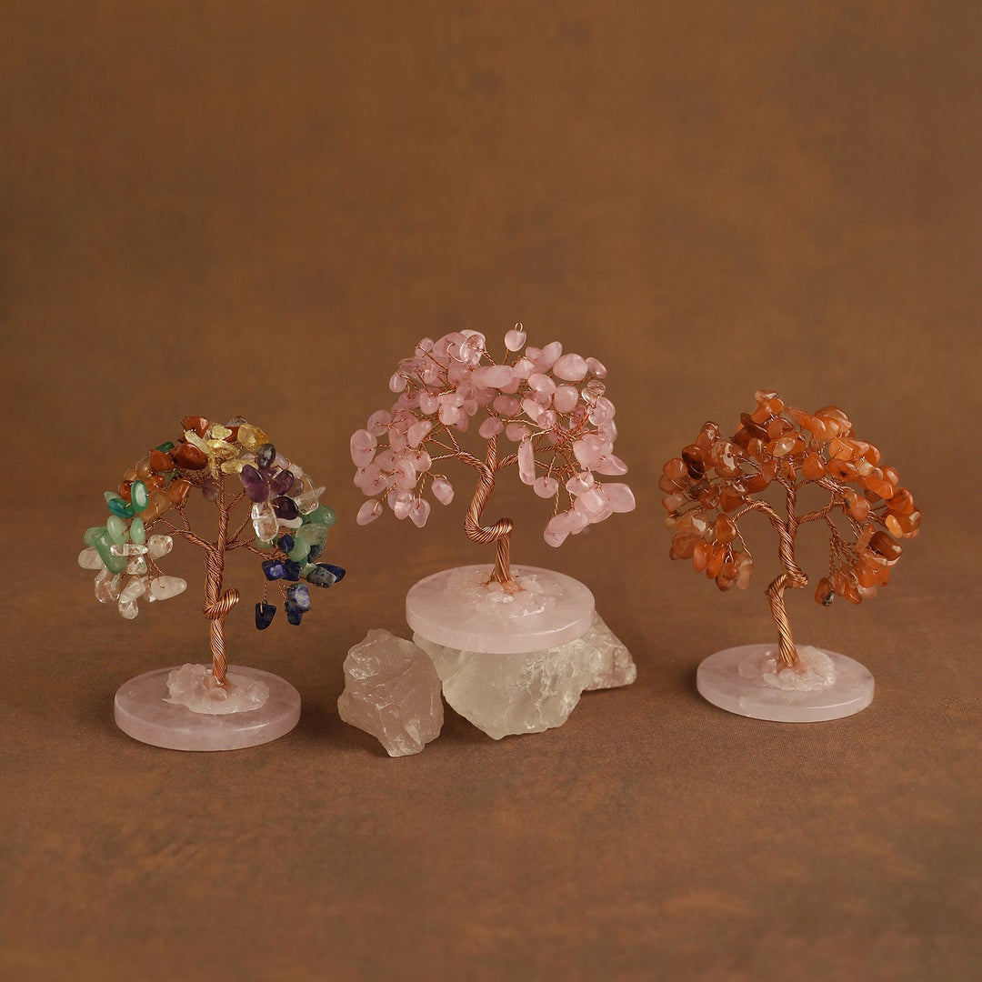 Three mini gemstone crystal trees with pink, gold, and orange crystal branches on bases