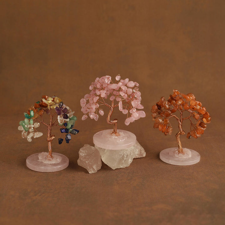 Three mini gemstone crystal trees with pink, gold, and orange crystal branches on bases