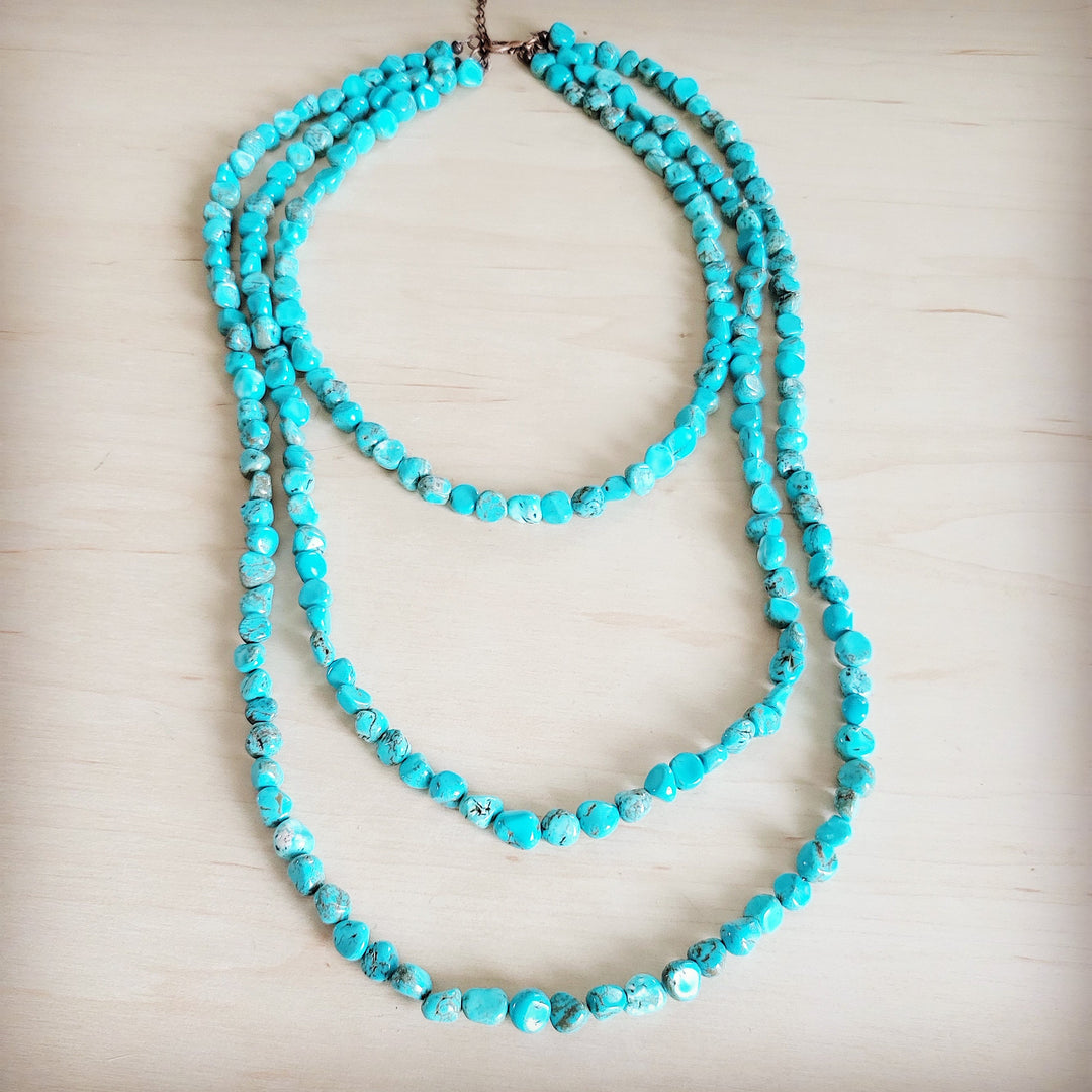 Turquoise triple-strand layered beaded necklace with brown clasp