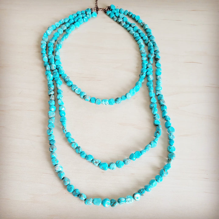 Turquoise triple-strand layered beaded necklace with brown clasp