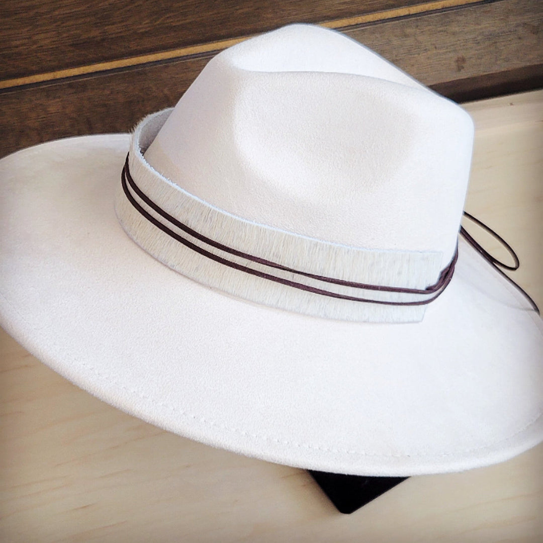 White wide-brim felt hat with dark hat band and tied cord detail