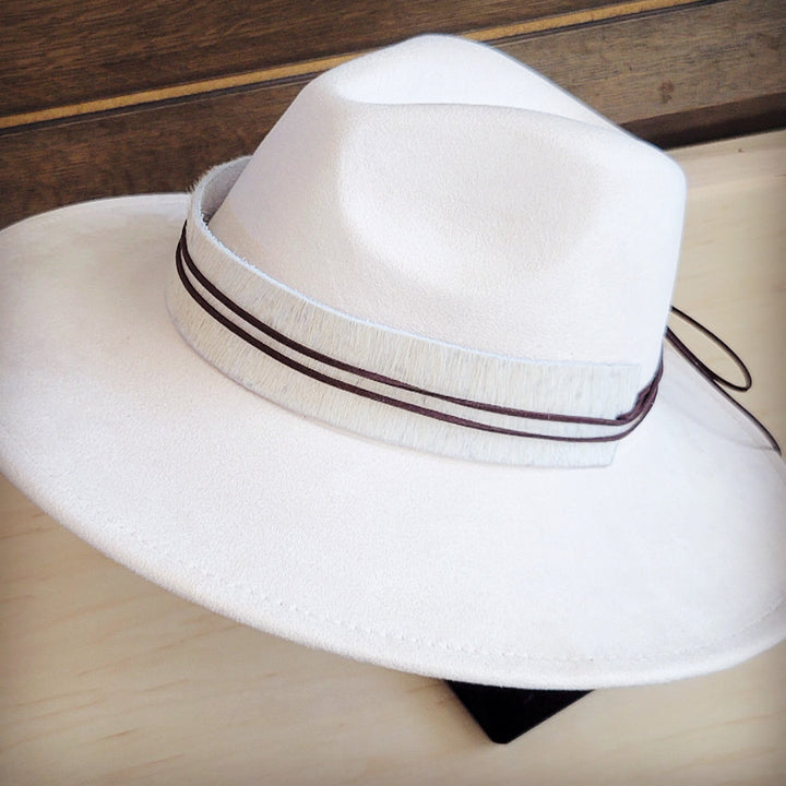 White wide-brim felt hat with dark hat band and tied cord detail