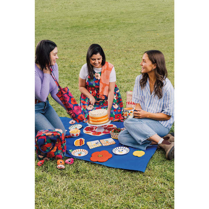 Mini citrus plates on a picnic blanket, round designs with rabbits and fruit