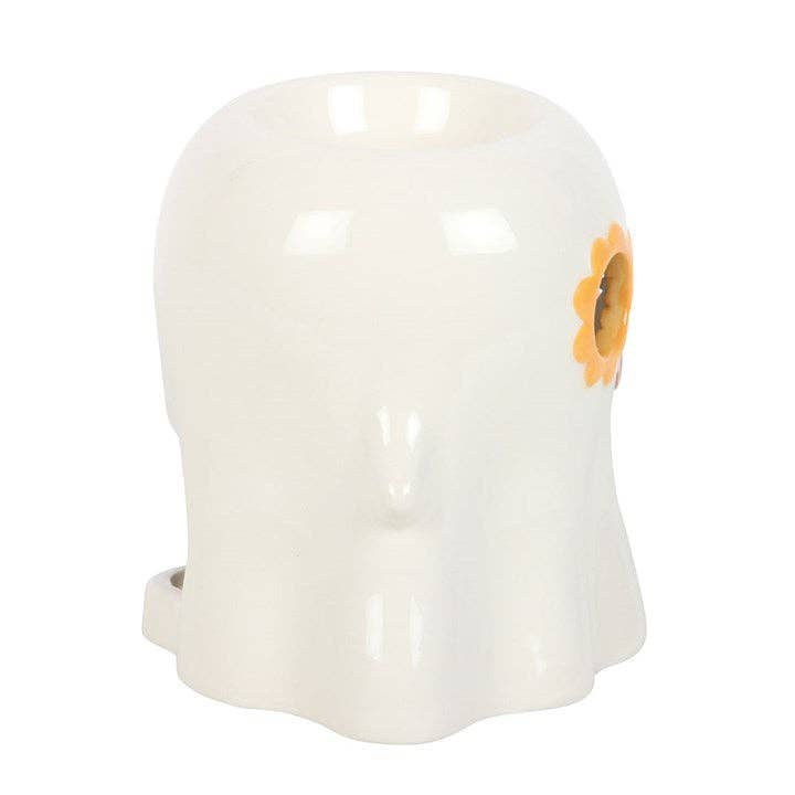White ghost wax warmer with orange flower glasses detail on the side.