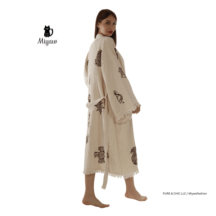 Beige cotton kimono bathrobe with Aztec print motifs and fringe, side view