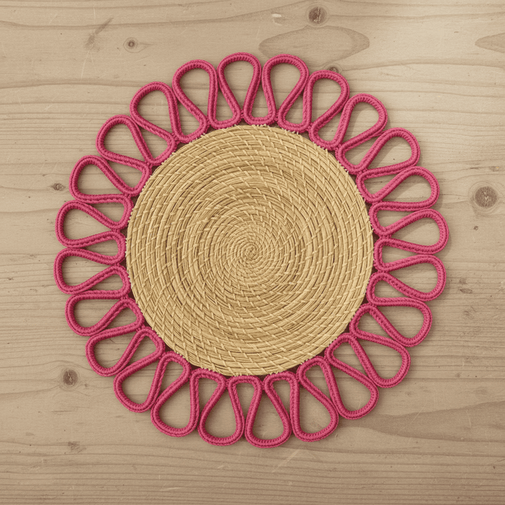 Round handwoven iraca placemat with light blue loop trim and tan woven center
