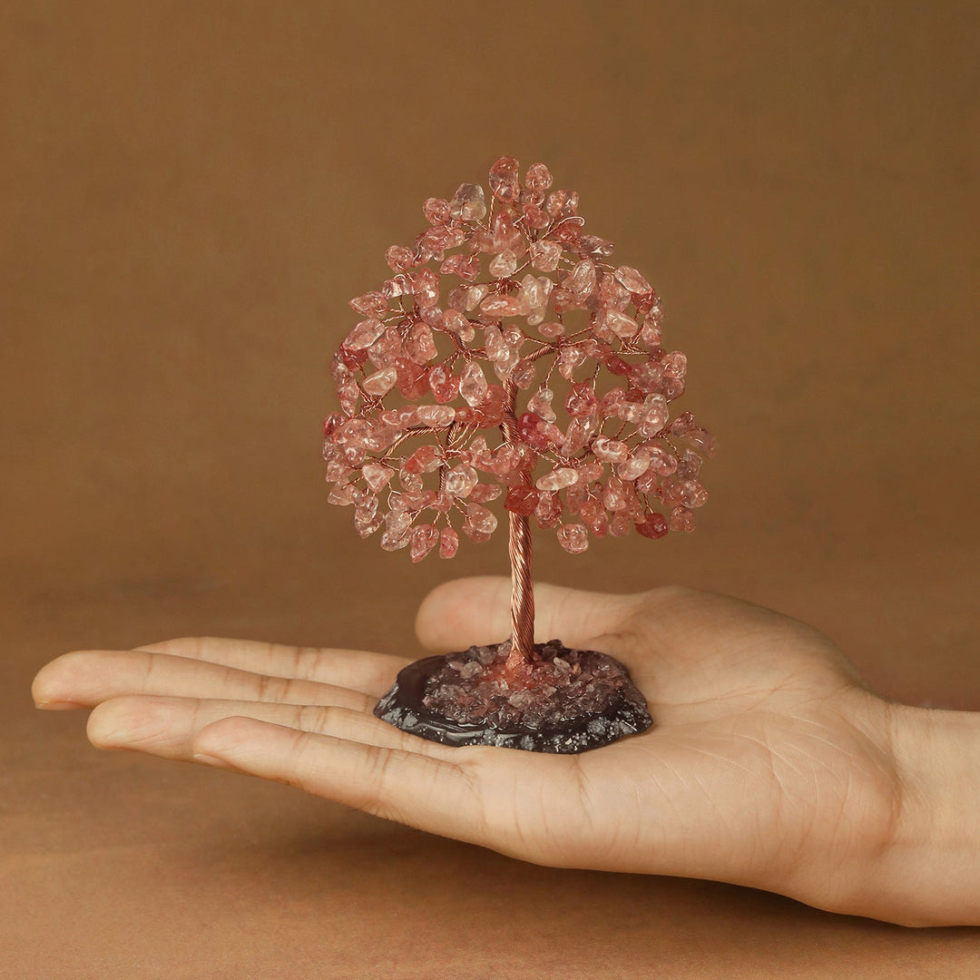 Pink crystal tree figurine with dense crystal branches and a thin trunk on a base