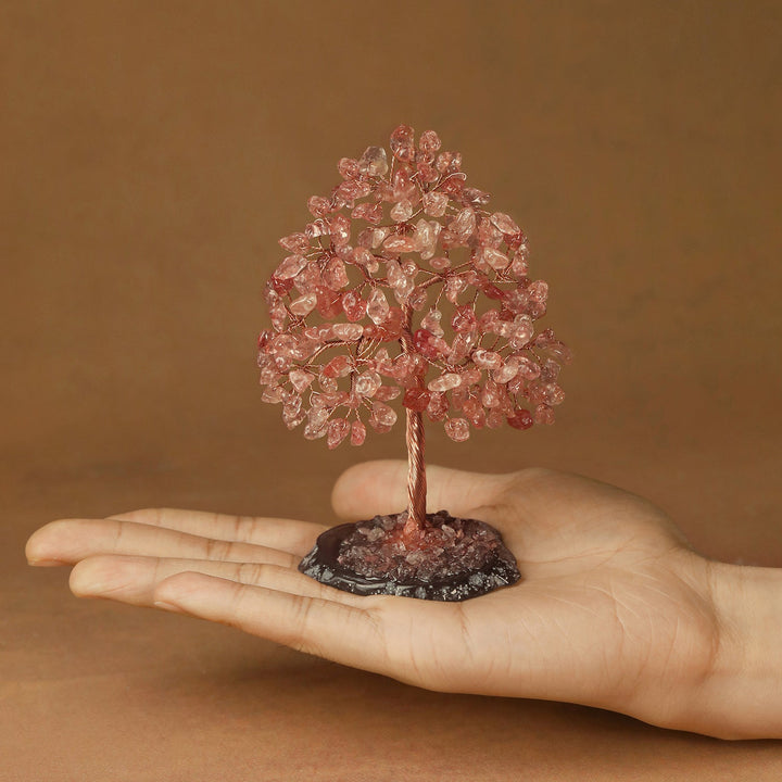 Pink crystal tree figurine with dense crystal branches and a thin trunk on a base