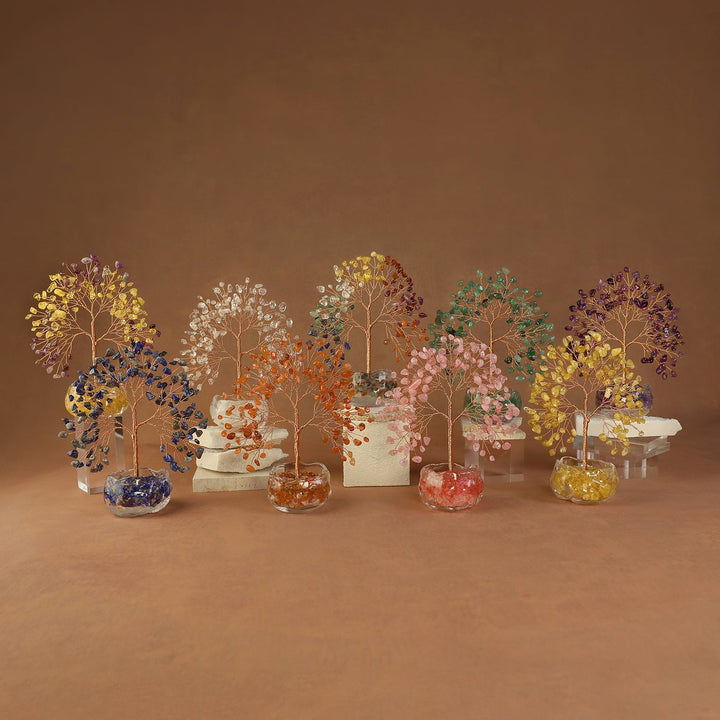 Colorful crystal tree ornaments with gemstone leaves on clear round bases