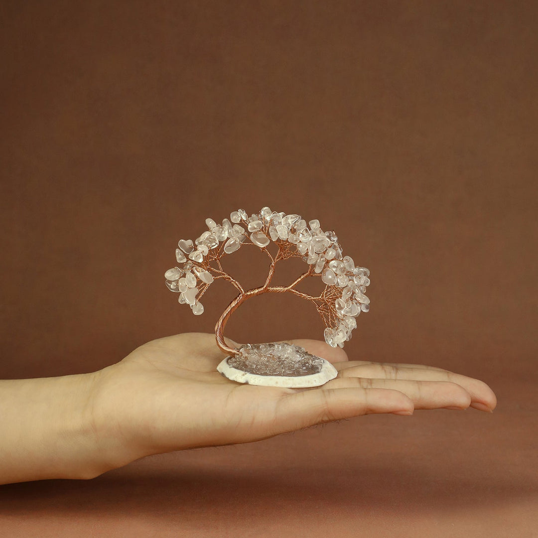 Clear beaded crystal tree ornament with copper wire branches on a stone base
