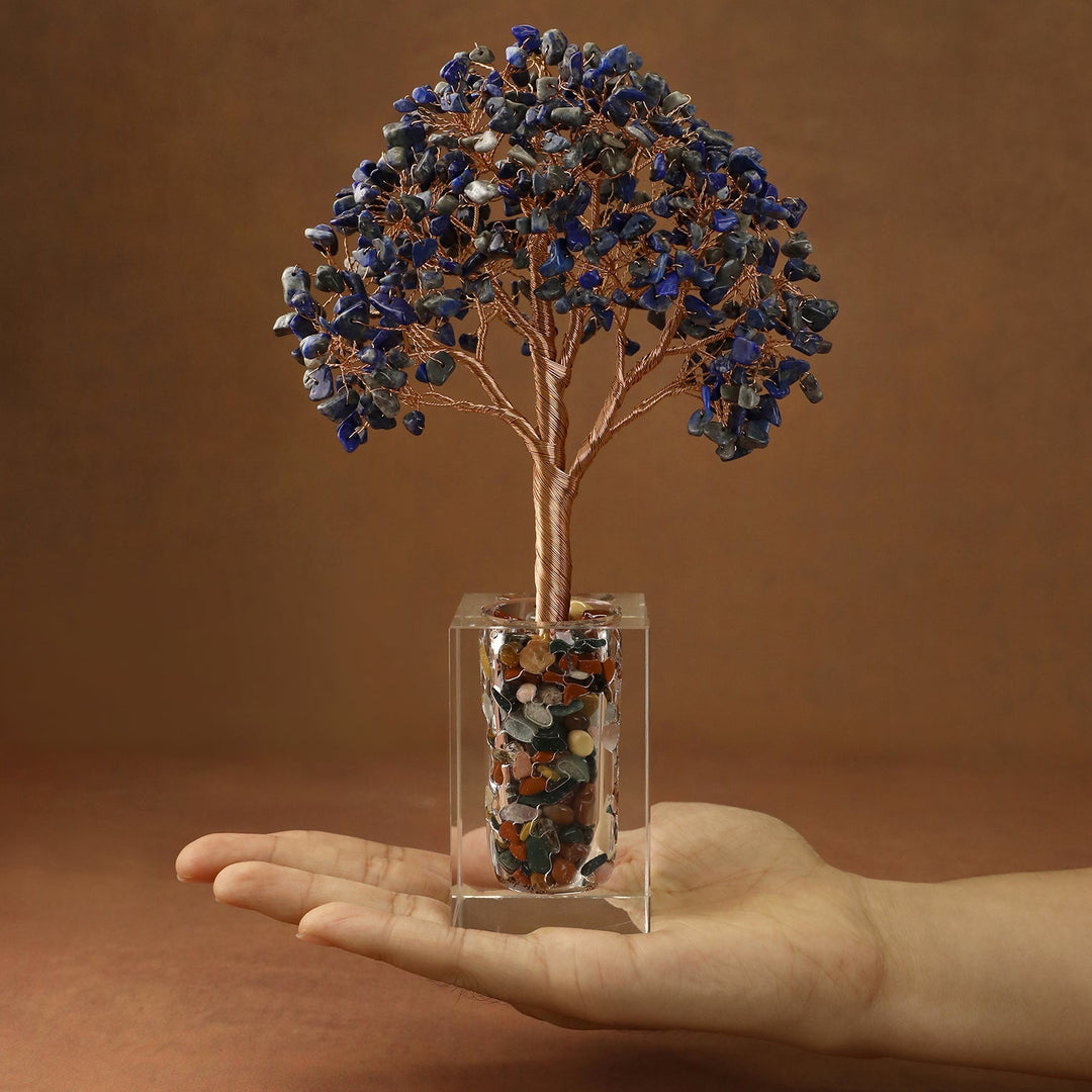 Blue crystal tree with faceted stone branches and a clear cube base filled with stones