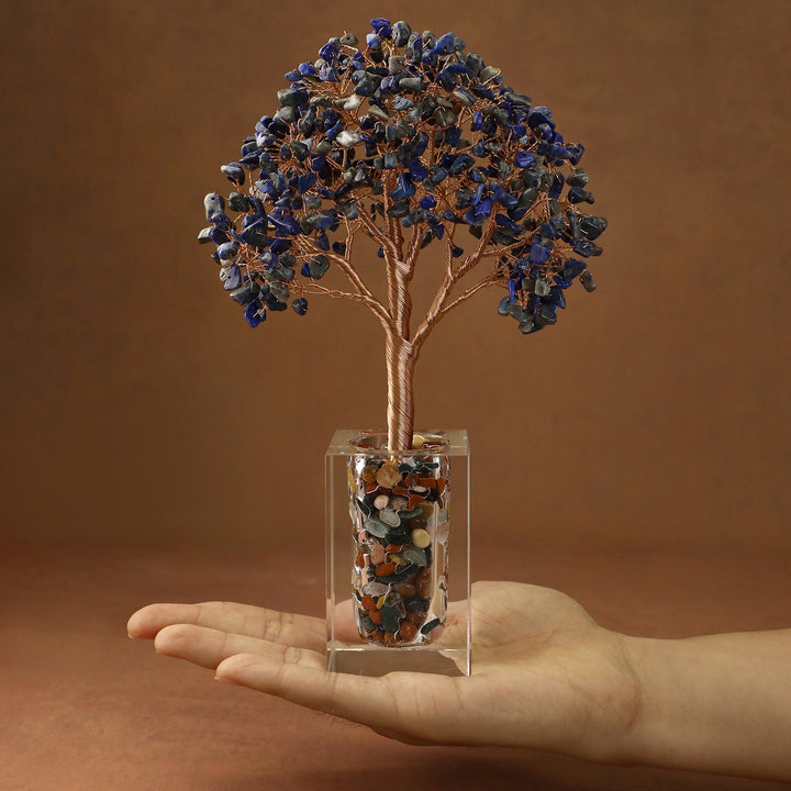 Blue crystal tree with faceted stone branches and a clear cube base filled with stones