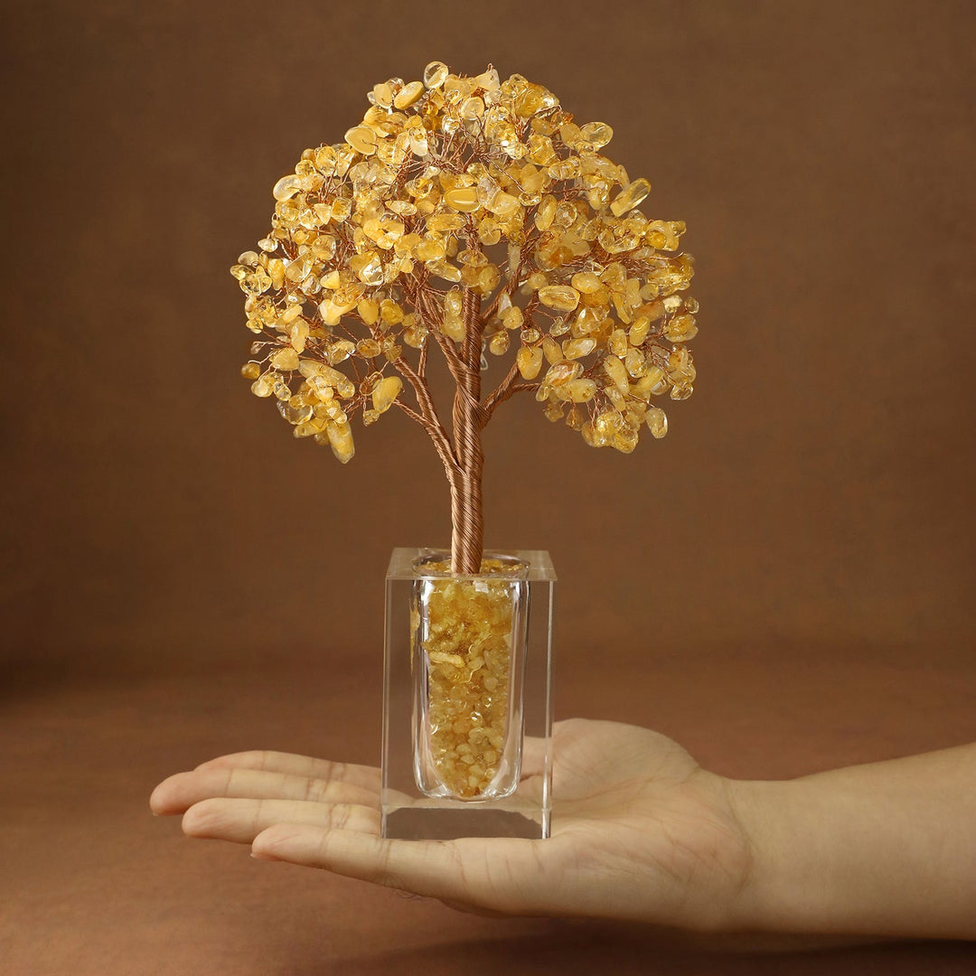 Golden crystal tree with faceted stones on branches, set in a clear cube base