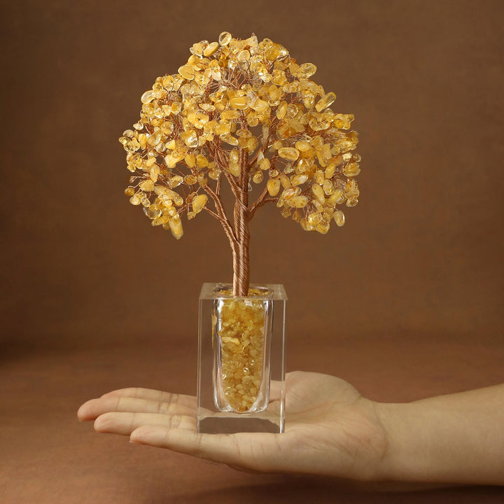 Golden crystal tree with faceted stones on branches, set in a clear cube base