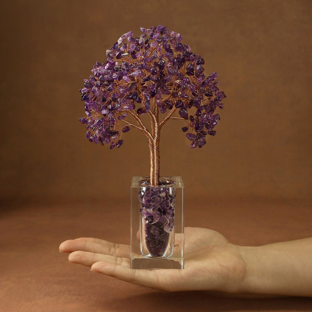 Purple crystal tree with branch-like branches and faceted stones in a clear cube base