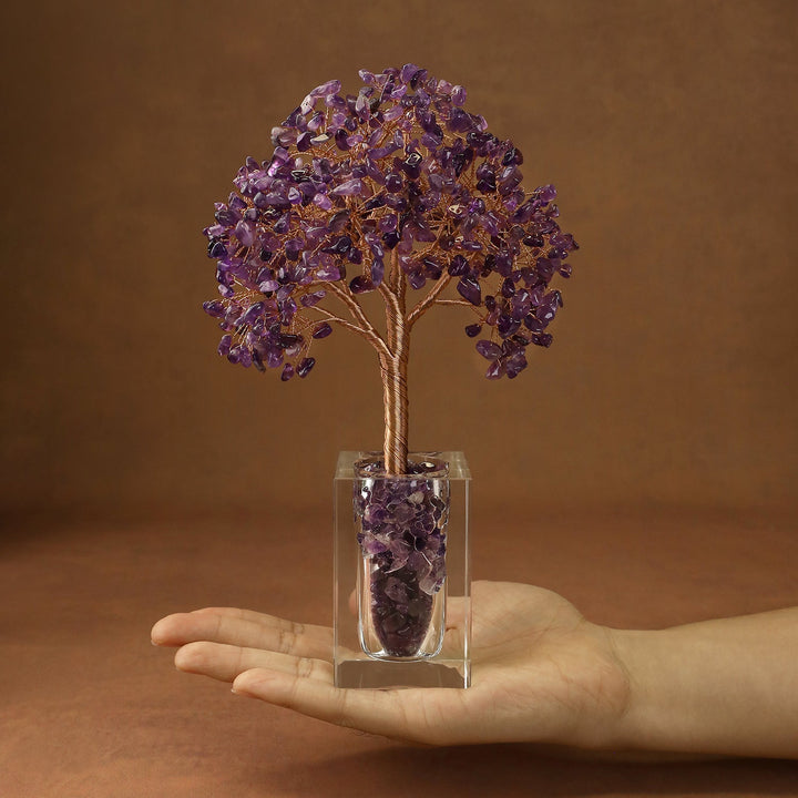Purple crystal tree with branch-like branches and faceted stones in a clear cube base