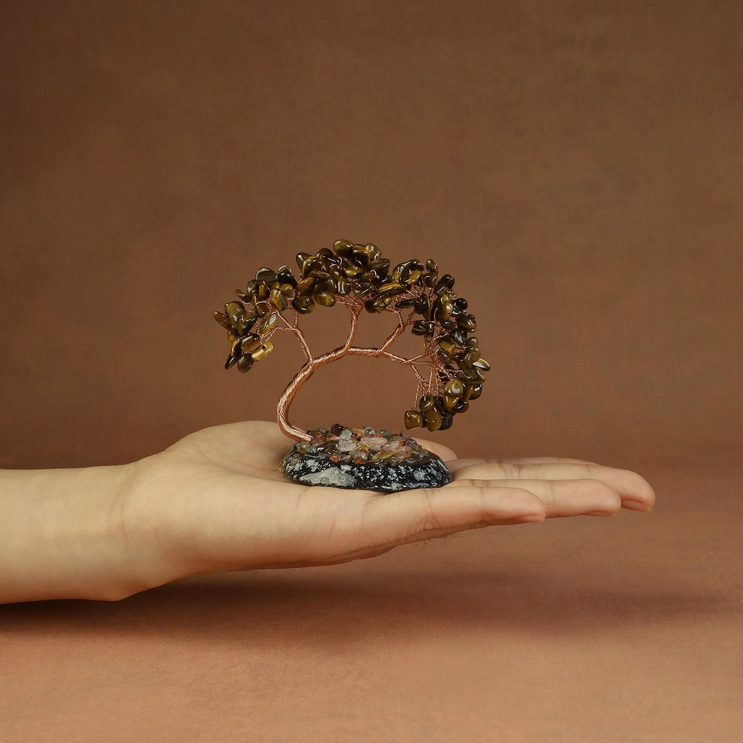 Gold-brown beaded crystal tree ornament with copper wire branches on a stone base
