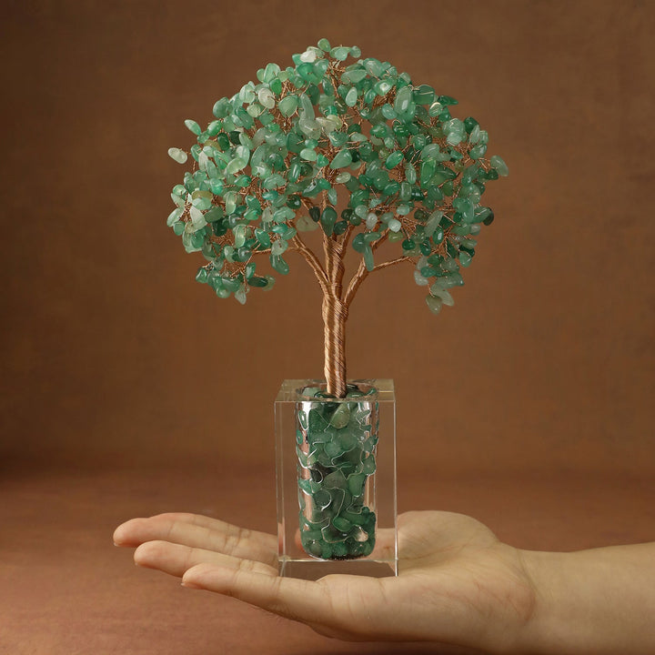 Green crystal tree with faceted stone branches and a clear cube base
