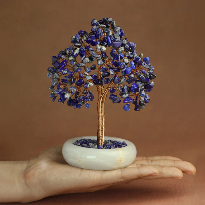 Blue crystal gemstone tree with twisted brown trunk on white jade-style base