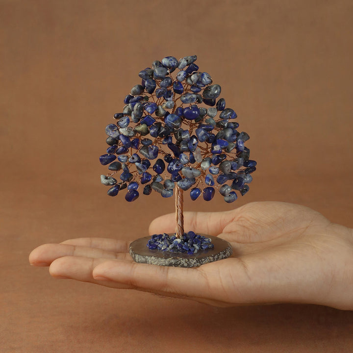 Blue crystal tree figurine with small stone branches and trunk on a circular base