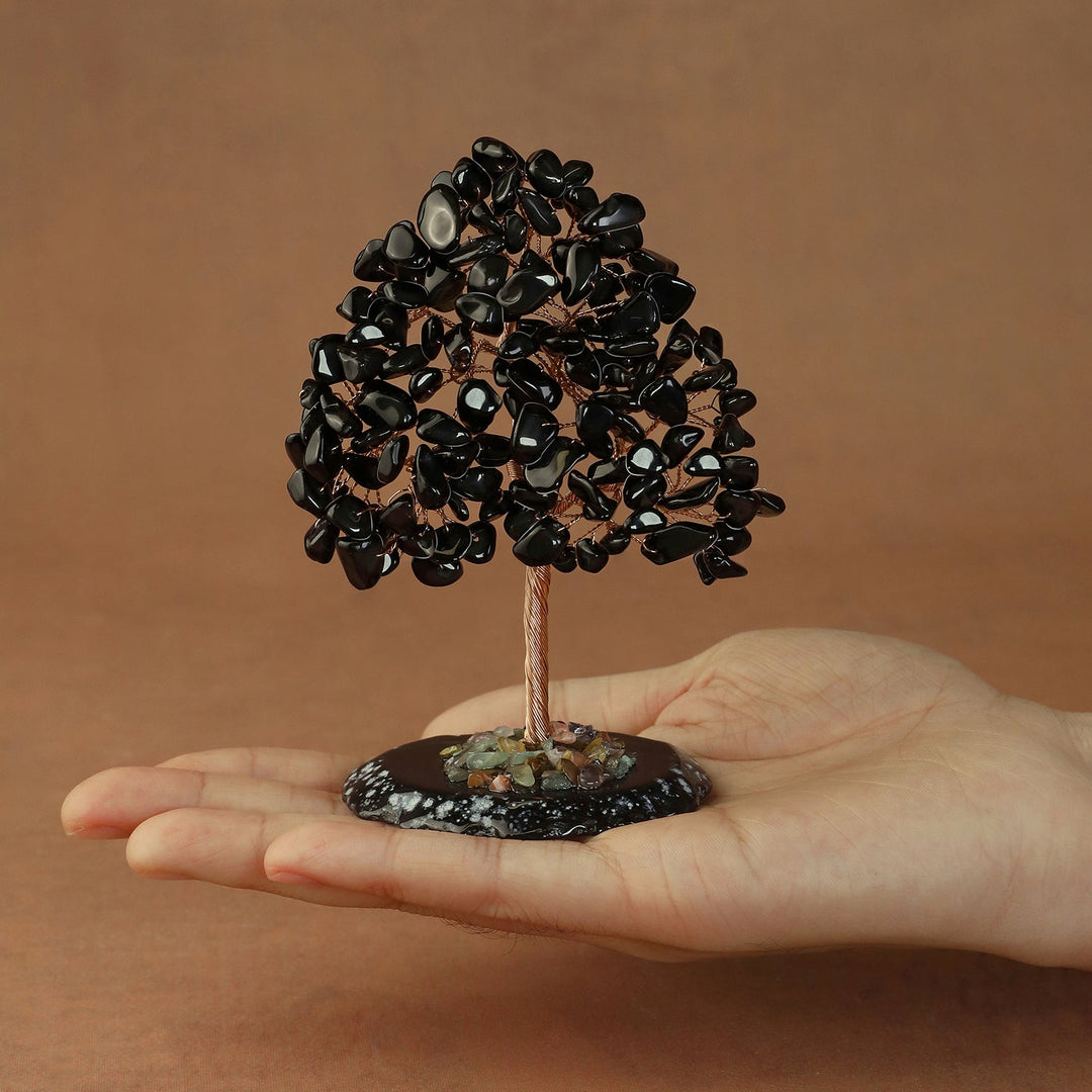 Black crystal tree figurine with clustered stones on a circular base and thin trunk