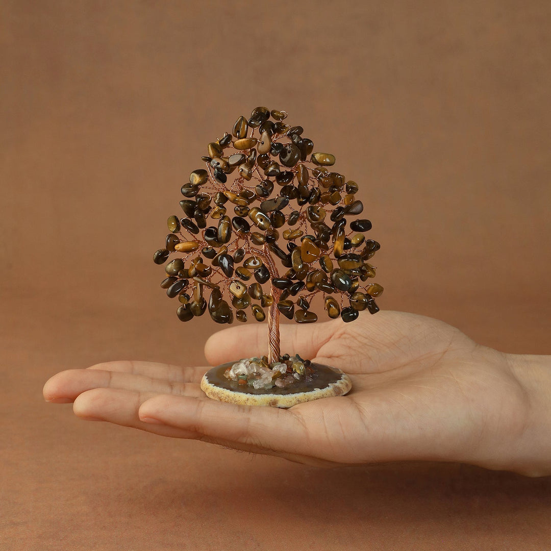 Golden crystal tree figurine with glossy stone branches and a wired trunk on a base