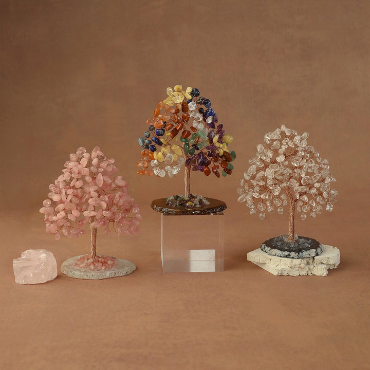 Three crystal bead trees in pink, rainbow, and white on stone bases