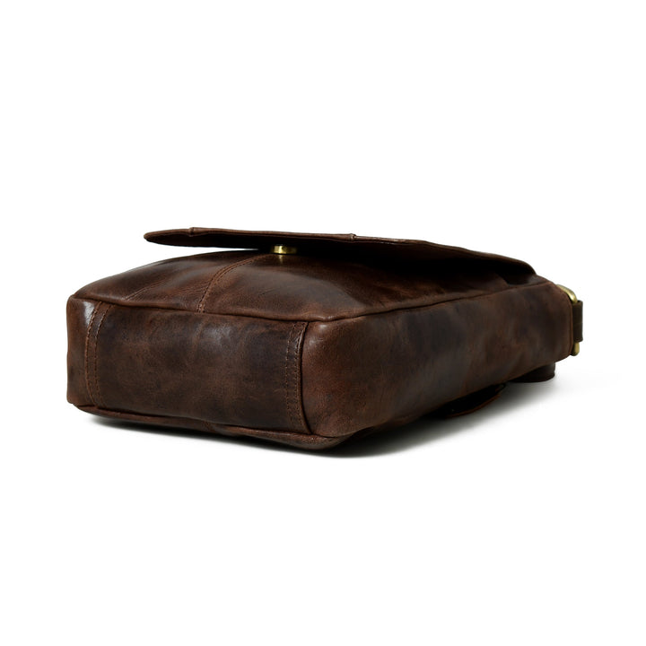 Brown leather messenger bag side and bottom view with low-profile shape and strap hardware
