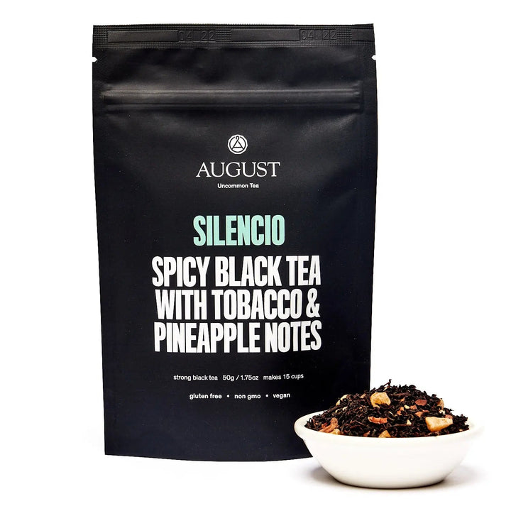 Black tea pouch with bold text: Silencio Spicy Black Tea &amp; pineapple notes