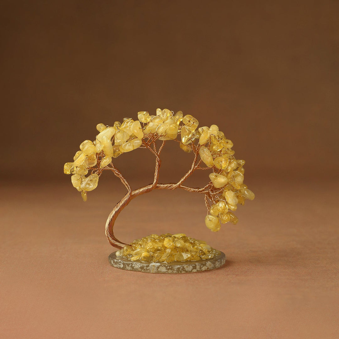 Yellow gemstone crystal tree with wire branches and chips on a round stone base