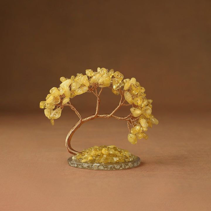 Yellow gemstone crystal tree with wire branches and chips on a round stone base