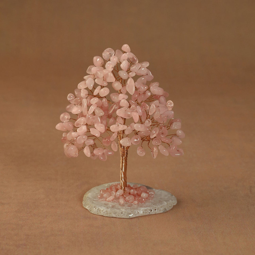Rooted crystal tree with pink rose quartz chips on a round stone base