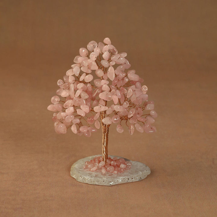 Rooted crystal tree with pink rose quartz chips on a round stone base
