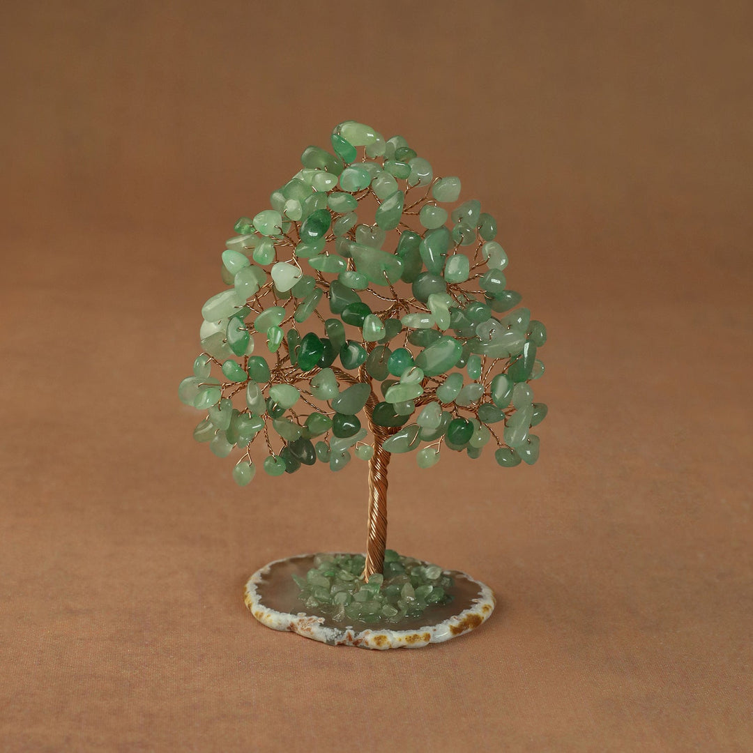 Rooted crystal tree with green aventurine chips on a round stone base